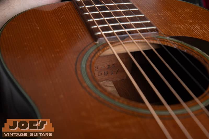 Neck-block stamp through the soundhole of a 1950 Martin 5-18, showing model 5-18 over serial 115817.